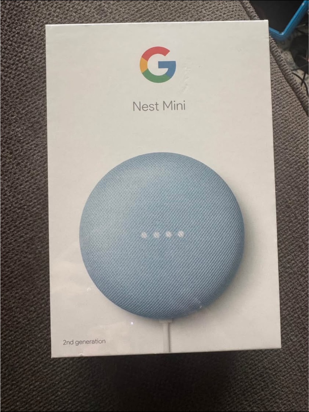 google smart speaker box with blue, red, yellow, green accents